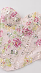 Close-up detail of sweetheart neckline and sequin floral embroidery
