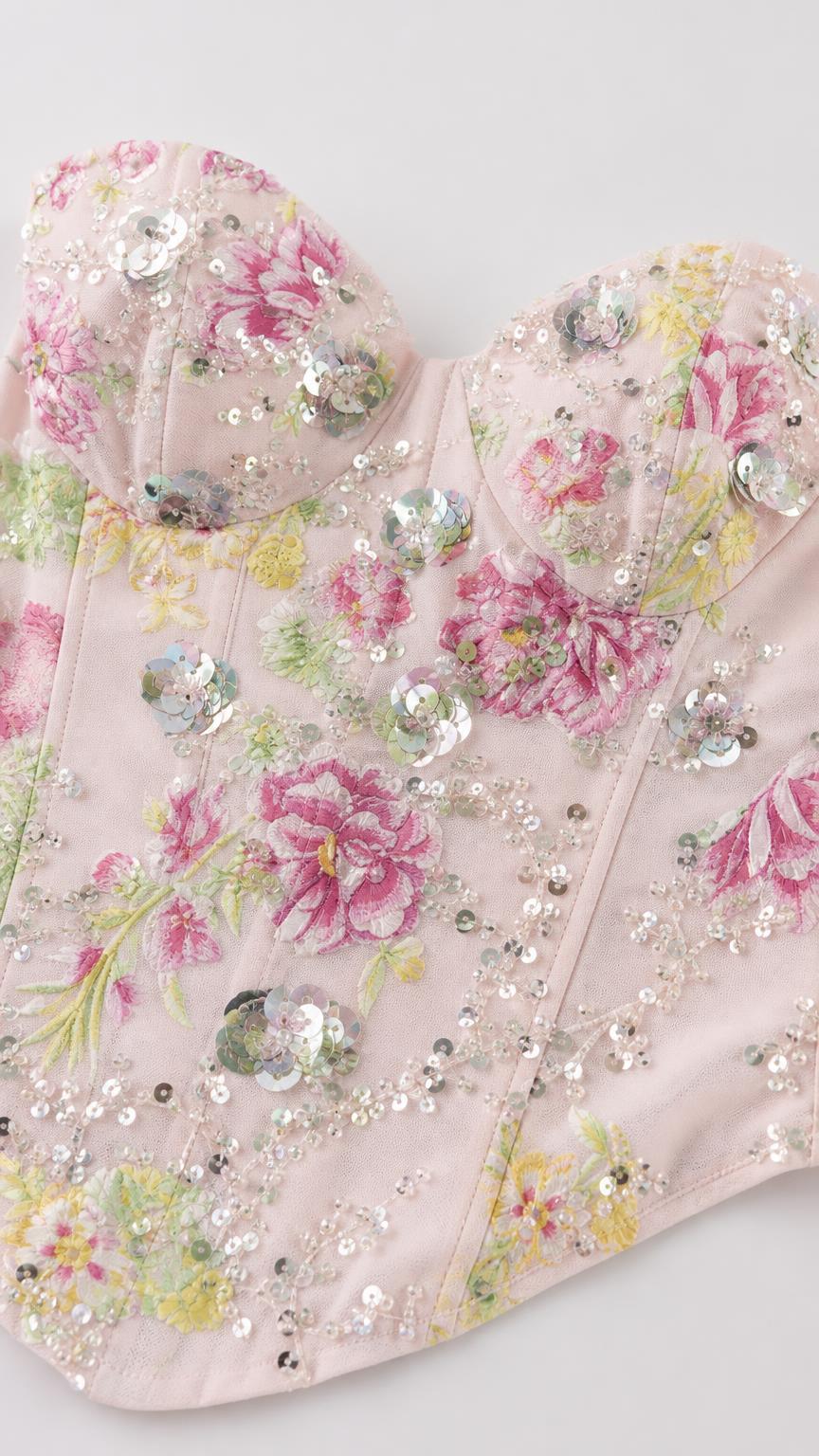 Close-up detail of sweetheart neckline and sequin floral embroidery