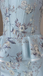 Close-up of structured floral corset bodice and peplum hem