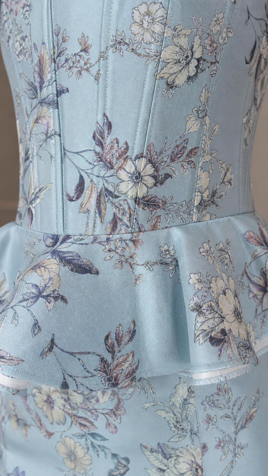 Close-up of structured floral corset bodice and peplum hem