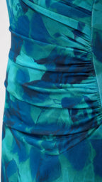 Close-up of side ruching detail on teal dress