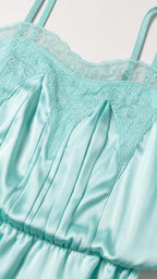 Close up of mint satin romper lace bodice detail