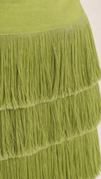 Close up view of the fringe tiers on the olive green dress