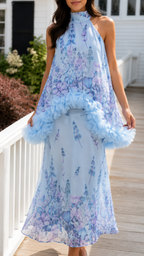 Close front view of powder blue floral halter maxi dress with layered trim