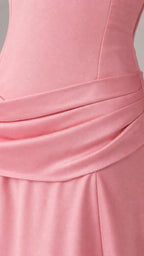 Close-up detail of draped drop-waist on pink dress