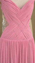 Close-up of pink bodice with crisscross pleating and button details