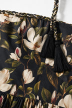 Close-up of fabric pattern, braided strap, and tassel detail