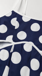 Close up of neckline and strap detail of polka dot dress