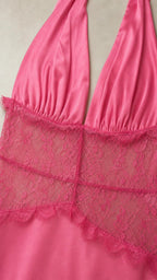 Close-up detail of lace bodice and halter neck on pink dress