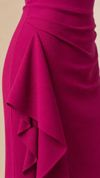 Close-up detail of side ruffle cascade on fuchsia dress