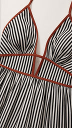 Close-up of V-neckline and contrast piping detail