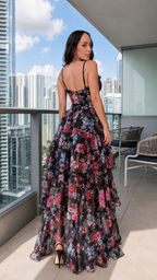 Back view of black floral strappy maxi dress with open back and cascading ruffles