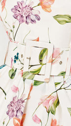 Close up of floral pattern and belt buckle detail on romper