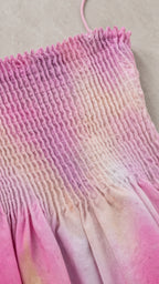 Close-up detail of smocked bodice and tie-dye fabric texture