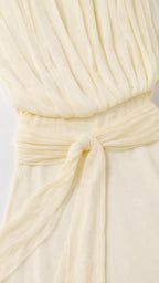 Close-up of bodice pleating and waist tie on yellow dress