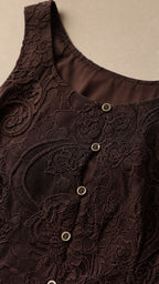 Close-up detail of dark brown lace fabric and front buttons