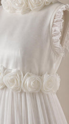 Close up of 3D rosette waist detail and ruffled shoulder