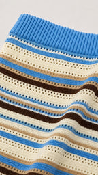 Close-up detail of blue multi open-stitch striped knit texture