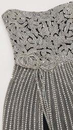 Close-up detail of the intricate bodice beadwork and rhinestone patterns