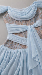 Close-up detail of sheer lace bodice and ruched chiffon sash