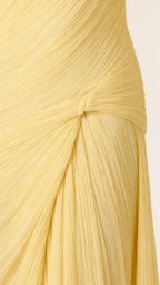 Close-up detail of pleated texture and side knot on yellow maxi dress