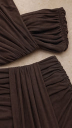 Close-up detail of fabric texture and ruching on the brown set