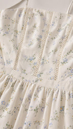 Close-up detail of bodice and lace trim on ivory floral dress