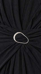 Close-up detail of metal ring waist accent on black dress