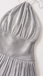 Close-up detail of pleated fabric and bodice on silver dress
