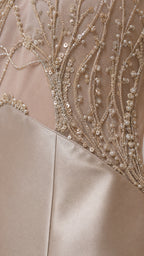 Close-up detail of intricate bead and sequin embroidery on mesh panel