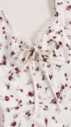 Close-up of lace trim and tie detail on White floral dress