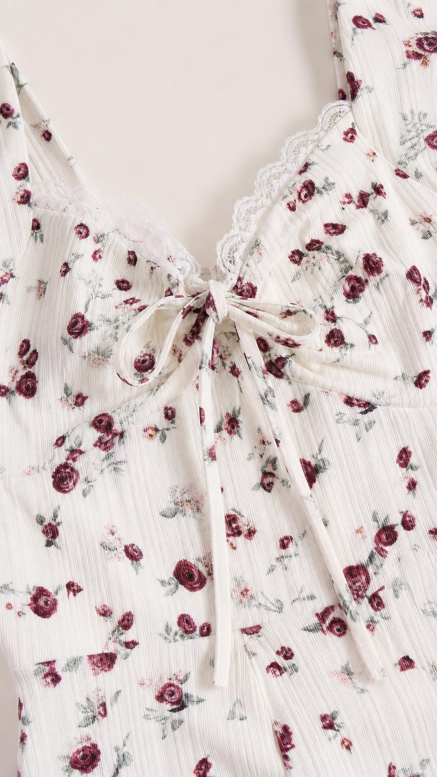Close-up of lace trim and tie detail on White floral dress