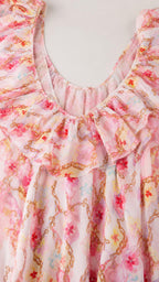 Close up of ruffle collar and scoop neckline