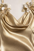 Close-up of 3D floral strap details and cowl neckline