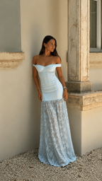 Angled front view of powder blue ruched bodycon maxi dress with sheer lace-look lower skirt