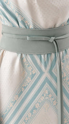 Close-up detail of the matching waist sash and geometric pattern