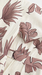 Close-up detail of tropical leaf print and sleeve construction