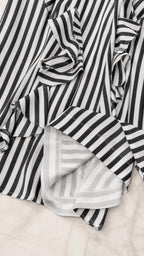 Close-up detail of fabric, ruffles, and stripes
