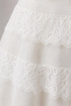 Close-up detail of white tiered lace trim on dress