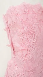 Close up of pink 3d floral applique texture on dress
