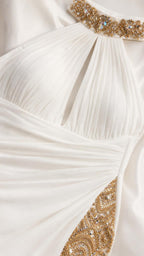 Close-up detail of crystal collar and ruched bodice on white dress