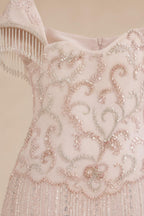 Close-up detail of the bodice embroidery and fringe sleeves