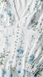 Close-up of V-neckline, buttons, and floral print fabric
