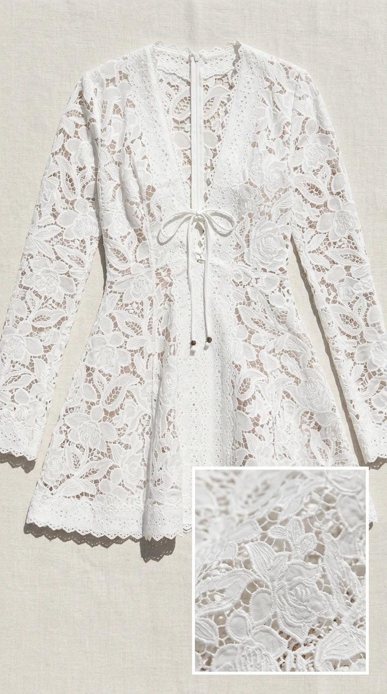 Flat lay of white lace dress showing fabric texture detail