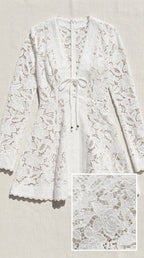 Flat lay of white lace dress showing fabric texture detail