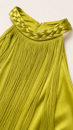 Close-up of braided halter neckline and fringe texture in olive