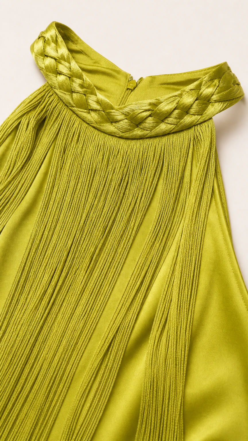 Close-up of braided halter neckline and fringe texture in olive