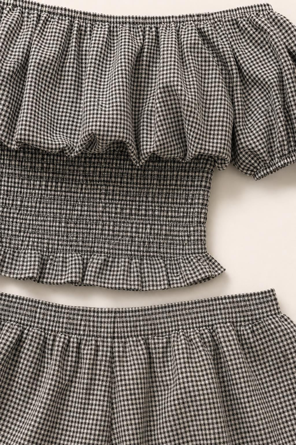 Close-up of ruffled off-the-shoulder neckline and smocked top