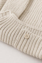 Close-up detail of knit texture and button accent