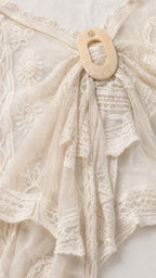 Close-up detail of resin ring and lace texture